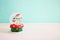 Image of christmas glass ball with snowman in front of pastel blue background