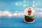 Image of christmas snow glass ball with santa claus in front of glitter blue background