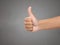image of the close shot of someone hand showing thumbs up.