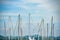 Image close up of boat pole in Marina with docked yachts and moored boats in calm blue sky