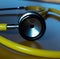 Image of close up with detail of yellow stethoscope on blue background