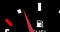 Image of close up of fuel gauge moving over black background
