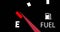 Image of close up of fuel gauge moving over black background