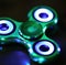 Image of close up of metallic fidget spinner on black background