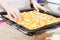 Image of closeup on woman hands preparing a delicious pizza with peppers