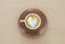 Image of coffe cup with foam of heart shape over wooden table.