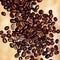 Image of coffee beans in detail. A scattering of grains lies diagonally.