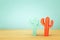 Image of colorful cactus decoration infront of wooden blue background.