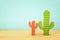 Image of colorful cactus decoration infront of wooden blue background.