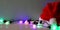 Image of colorful garland lights next to santa hat