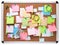 Image of colorful sticky notes on cork bulletin board isolated