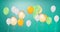 Image of colourful balloons bouncing on green background