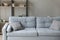Image of comfortable soft grey sofa with pastel pillows.