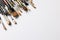 Image of composition of diverse brushes on white surface with copy space