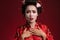 Image of confused asian geisha woman in traditional japanese kimono