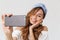 Image of content beautiful woman 20s smiling while taking selfie