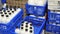 Image of crates of fresh farm cow's milk spilled in plastic bottles.