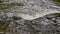 Image of the current of a river with water on some stones giving the appearance of a small waterfall