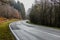 Image of a curve of a country road among forest trees