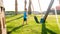 Image of cute little toddler boy playing with swings on the palyground at park