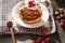 Image of delicious breackfast for family, pancackes with sour cream and fresh berries, muffins decorated with raspberries,