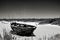 image of a deserted beach with an old boat broken fence around the dunes and clusters of sea oats.