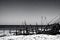 image of a deserted beach with an old boat broken fence around the dunes and clusters of sea oats.