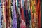 Image displaying an assortment of women\\\'s scarves in various colors arranged longitudinally