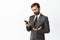 Image of displeased businessman looking at mobile phone app screen and grimacing slightly disappointed, checking