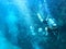 image of diver swimming underwater with lots of air bubbles