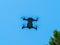 Image of a drone under the blue sky in full flight