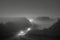 image of an early morning elevated shot of a dirt road winding through overgrown bush.