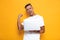 Image of ecstatic guy 30s in white t-shirt holding and using silver laptop