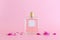 Image of elegant perfume bottle over pink pastel background