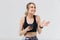 Image of energetic blond woman 20s dressed in sportswear using smartphone during workout in gym