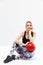 Image of energetic blond woman 20s dressed in sportswear working out and doing exercises with fitness ball