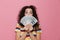 Image of european woman 20s with curly hair holding fan of dollar money, isolated over pink background