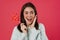 Image of excited brunette girl smiling while posing with lollipop