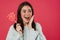 Image of excited brunette girl smiling while posing with lollipop