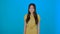Image of excited young lady standing isolated over blue background girl nods approvingly 4K