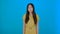 Image of excited young lady standing isolated over blue background sarcastic girl nods 4K