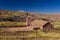 Image of facade of an ancien straw hatched  church with mud walls  . Taken during springtime at Socaire at Los Flamencos national