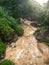 Image of fast stream of dirty water in mountains after heavy rain