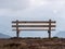 Image with focus of bench with mountains in the background
