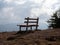 Image with focus of bench with mountains in the background