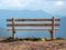 Image with focus of bench with mountains in the background