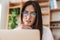 Image of focused adult businesswoman in eyeglasses working with laptop