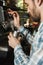 Image of focused barista man making coffee while working in cafe or coffeehouse outdoor