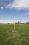 Image of football goal post with grass and blue