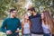 Image of four happy smiling young friends walking outdoors in the park